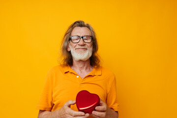 old man yellow t-shirt and glasses posing heart-shaped box cropped view