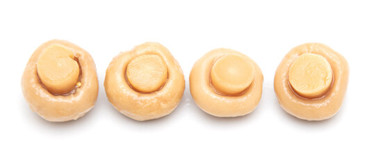 Pickled champignons isolated on a white background.