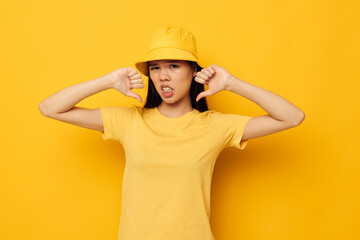 woman with Asian appearance in a yellow t-shirt and hat posing emotions Monochrome shot