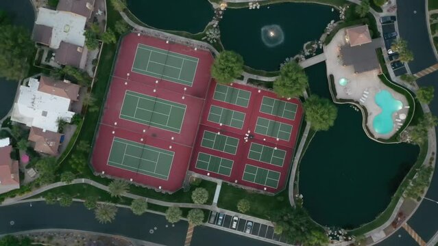 Aerial Top View Of Tennis Courts And Outdoor Swimming Pool In A Resort In California. rotating shot. Palm Springs, CA.