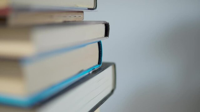 Stack Of Reading Books In The Table. - tilt up, rack focus