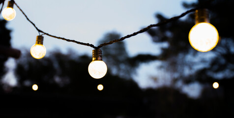 Yellow light bulb at twilight time