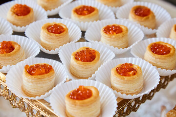 Snack in the buffet at the event. An assortment of delicious food on a tray. Banquet service, restaurant on the road. Food, meat snacks, homemade, bread and tomatoes, seafood snacks