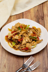 Chinese chicken dish. Chicken with olive oil and soy sauce. Traditional Chinese dish prepared with garlic, onion, capia pepper and green pepper