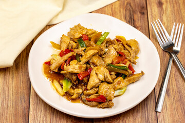Chinese chicken dish. Chicken with olive oil and soy sauce. Traditional Chinese dish prepared with garlic, onion, capia pepper and green pepper