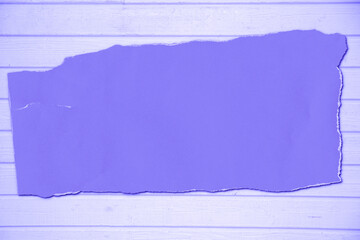 crumpled paper purple sheet on violet wooden background