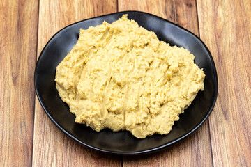 Hummus in a ceramic plate. Dishes of chickpeas, a vegetarian dish.