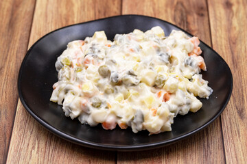 Potato salad with mayonnaise. Traditional salad with cooked vegetables with mayonnaise. Russian salad