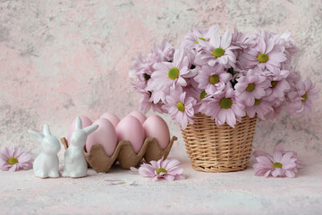 Two porcelain bunnies, pink eggs a bouquet of flowers  