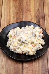 Potato salad with mayonnaise. Traditional salad with cooked vegetables with mayonnaise. Russian salad
