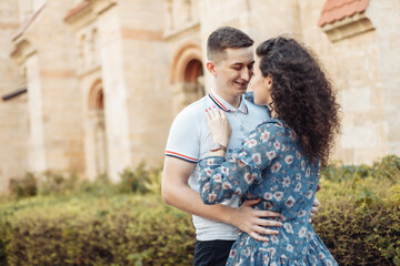 Fototapeta premium Young couple in love hug in a European city. Feeling in love, romantic concept