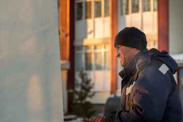 Worker on the installation of an ice panel