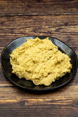 Hummus in a ceramic plate. Dishes of chickpeas, a vegetarian dish.