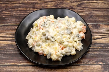 Potato salad with mayonnaise. Traditional salad with cooked vegetables with mayonnaise. Russian salad