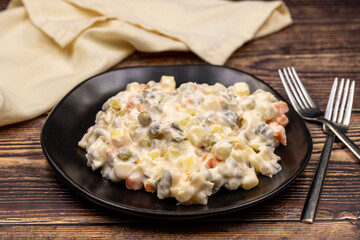 Potato salad with mayonnaise. Traditional salad with cooked vegetables with mayonnaise. Russian salad