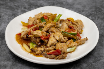 Chinese chicken dish. Chicken with olive oil and soy sauce. Traditional Chinese dish prepared with garlic, onion, capia pepper and green pepper