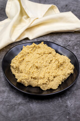 Hummus in a ceramic plate. Dishes of chickpeas, a vegetarian dish.