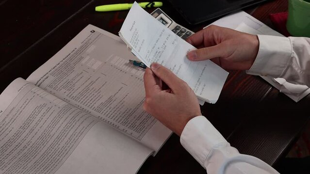 Slow motion of receipt sorting for a tax filing.