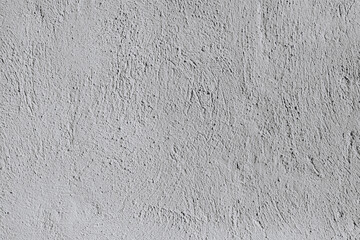 Background from a seamless pattern of gray stone wall covered with decorative plaster.