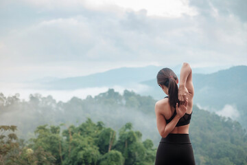 athlete woman exercise in morning, Young fitness woman stretching muscle against mountain view,...