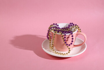 Ceramic cup with a garland on a pink bright background. Minimal christmas still life