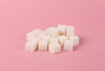 Sugar cubes on pink background