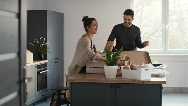 Caucasian couple packing some kitchen stuff and chatting. Shot with RED helium camera in 8K.