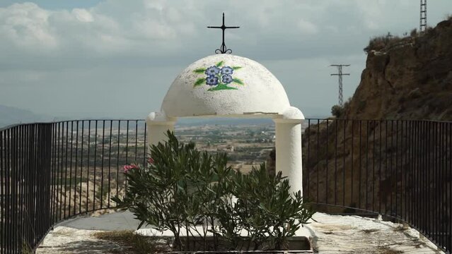 Centered shot of small christian cross cupula in Spain, static, day
