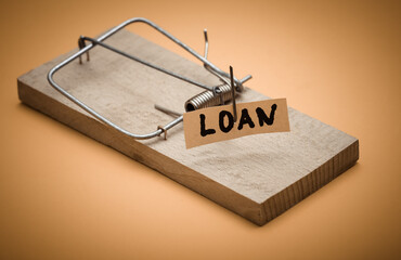 Mousetrap with loan bait on yellow background. Trap, risks or deception concept