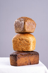 balancing bread on a table on a gray background.