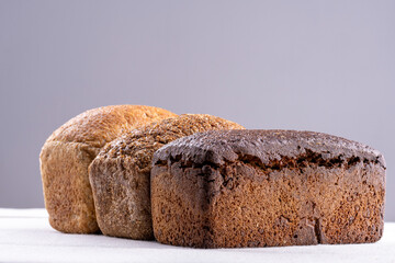 three loaves of homemade bread on a white table