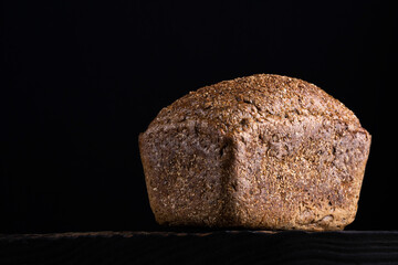 loaf of rye homemade bread in dark background