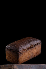 loaf of rye homemade bread in dark background