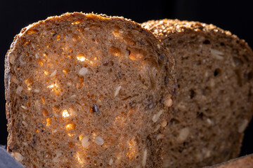 Bread, traditional homemade bread cut into slices on a rustic wooden background, close-up.