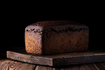 handmade bread over a wood with black background