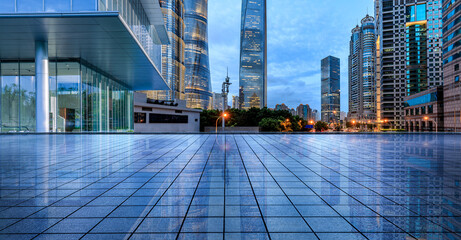 Fototapeta na wymiar Empty square floor and city skyline with modern commercial buildings at night in Shanghai, China.