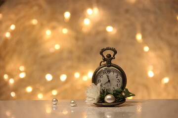old clock with flower and pearls