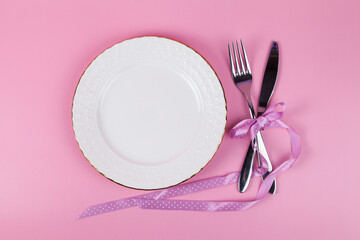 Festive set of cutlery knife and fork with a white dessert plate