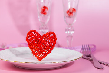 Valentine's day romantic dinner with red hearts on pink background.