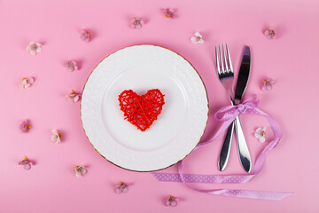 Valentine's day romantic dinner with red hearts on pink background.