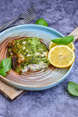 Obraz na płótnie Canvas Fish bake refined with spinach and gorgonzola cheese crust.White Code fish fillet stuffed with broccoli and creamy Alfredo sauce . Healthy food, delicious homemade italian lunch .