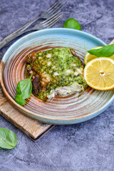 Fish bake refined with  spinach and gorgonzola cheese crust.White Code fish fillet stuffed  with broccoli  and  creamy Alfredo  sauce . Healthy food, delicious homemade italian  lunch .