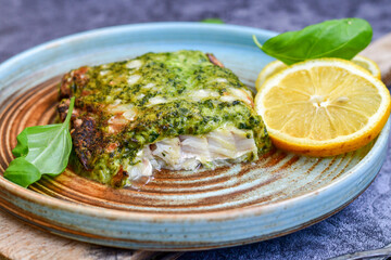 Fish bake refined with  spinach and gorgonzola cheese crust.White Code fish fillet stuffed  with broccoli  and  creamy Alfredo  sauce . Healthy food, delicious homemade italian  lunch .