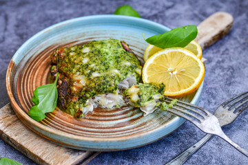 Fish bake refined with  spinach and gorgonzola cheese crust.White Code fish fillet stuffed  with broccoli  and  creamy Alfredo  sauce . Healthy food, delicious homemade italian  lunch .