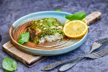 Fish bake refined with  spinach and gorgonzola cheese crust.White Code fish fillet stuffed  with broccoli  and  creamy Alfredo  sauce . Healthy food, delicious homemade italian  lunch . - obrazy, fototapety, plakaty