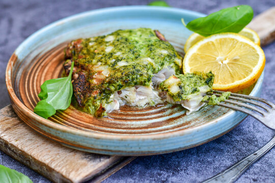 Fish Bake Refined With  Spinach And Gorgonzola Cheese Crust.White Code Fish Fillet Stuffed  With Broccoli  And  Creamy Alfredo  Sauce . Healthy Food, Delicious Homemade Italian  Lunch .