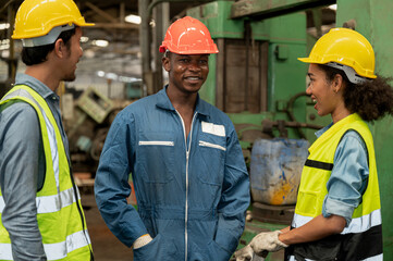 Happy mechanic with engineer team at metal factory