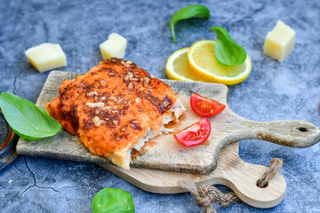 Fish bake preparated in Ticino style with sweet gorgonzola cheese and tomato crust