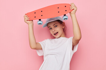 little girl with a skateboard in hand isolated background