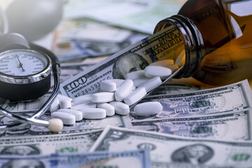 Medicines and a blood pressure monitor lie on banknotes. The concept is to raise the price of pharmaceuticals. Investing in pharmaceuticals. The cost of medicines.
